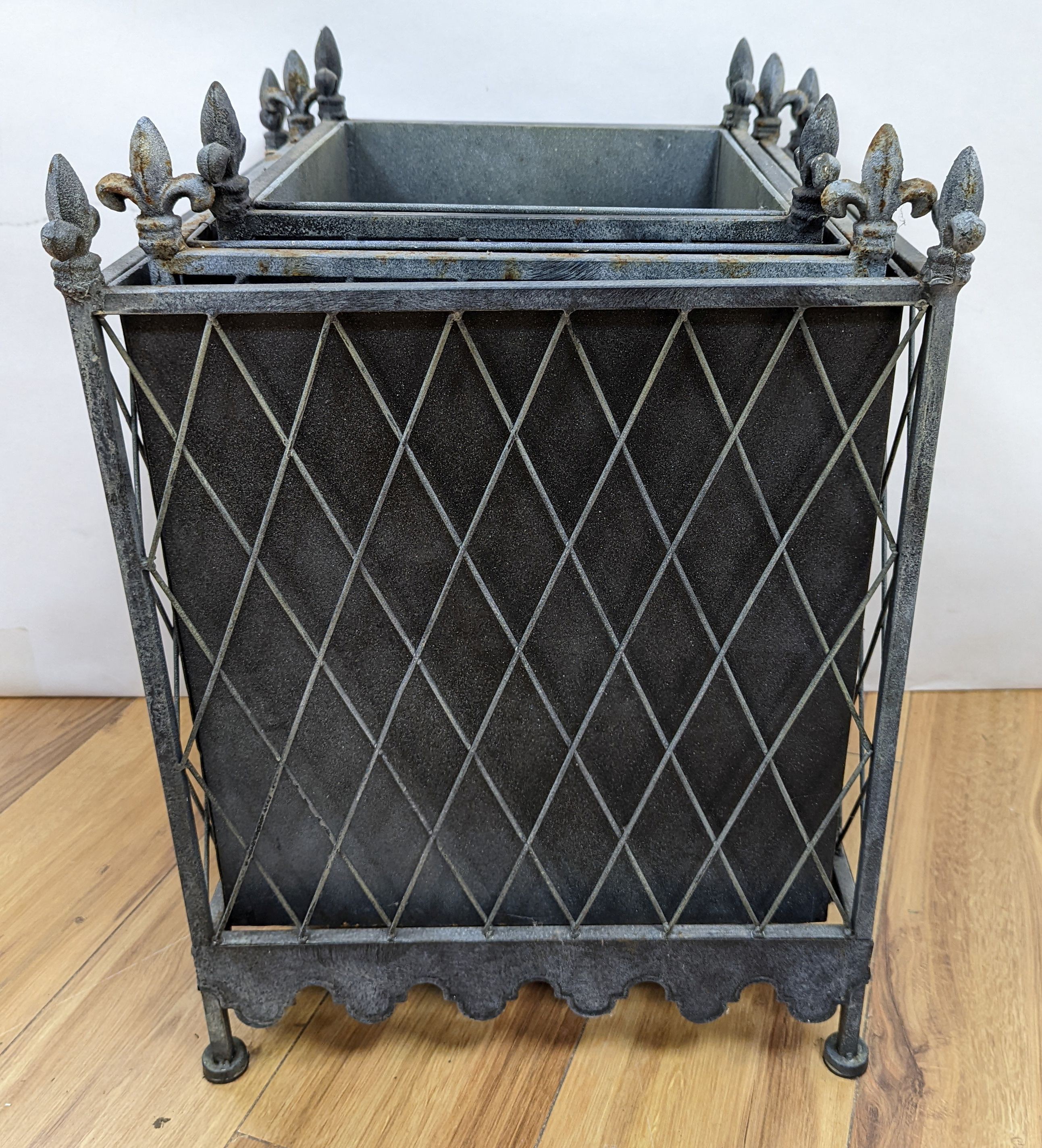 A graduated set of three zinc plated iron jardinieres, largest 41 cm wide, 51. 5 cm high